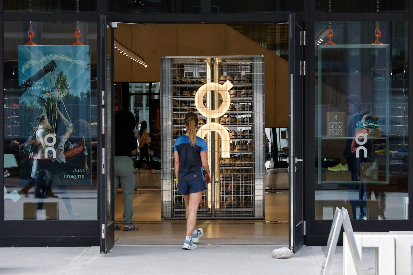 A runner enters the On Labs flagship store, operated by On Holdings AG, in Zurich, Switzerland, on Tuesday, March 21, 2023. Swiss sneaker maker On predicted that its tennis and running footwear will drive sales growth of almost 40% this year as the upstart eats into a sports footwear market traditionally dominated by larger rivals Adidas AG and Nike Inc. Photographer: Stefan Wermuth/Bloomberg via Getty Images